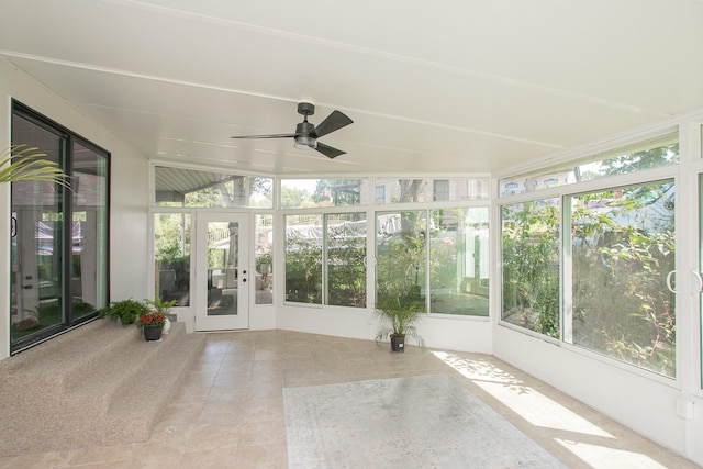 unfurnished sunroom featuring ceiling fan