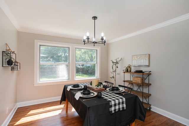 dining room featuring hardwood / wood-style flooring, crown molding, and a chandelier