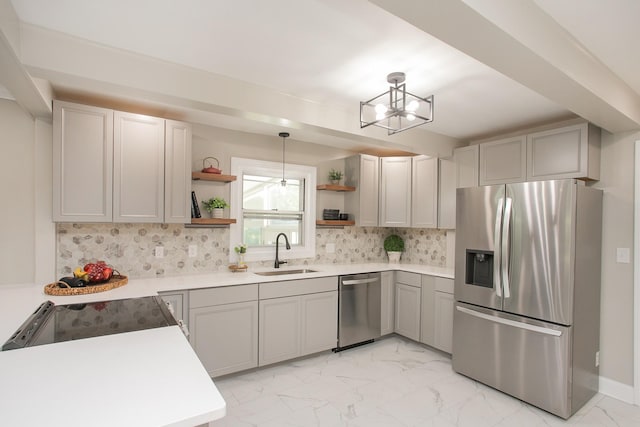 kitchen with sink, appliances with stainless steel finishes, gray cabinetry, hanging light fixtures, and tasteful backsplash