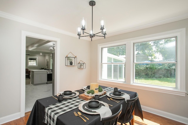 dining space with beamed ceiling, ornamental molding, coffered ceiling, and a notable chandelier