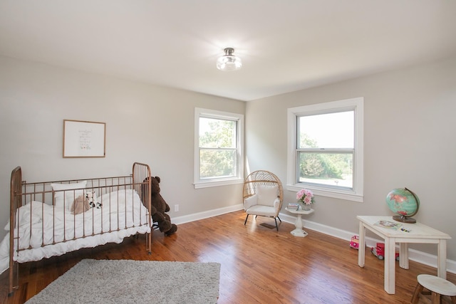 bedroom with dark hardwood / wood-style floors