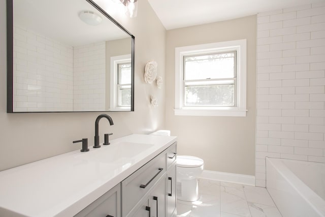 full bathroom featuring tiled shower / bath, vanity, and toilet