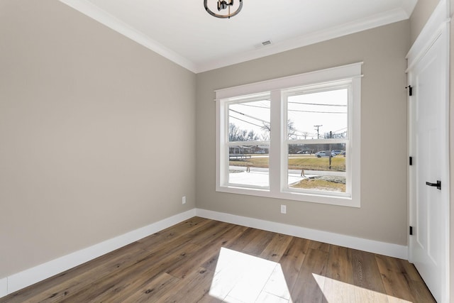 unfurnished room featuring crown molding and wood-type flooring