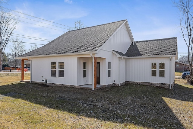 rear view of property with a lawn