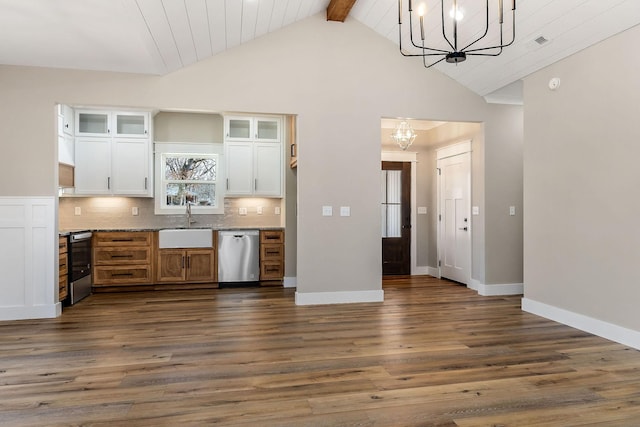 kitchen featuring decorative light fixtures, white cabinetry, sink, stainless steel appliances, and an inviting chandelier