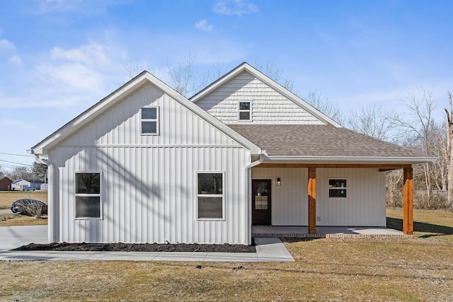 modern inspired farmhouse with a porch and a front yard