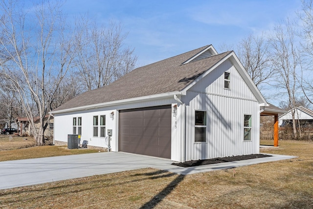 view of home's exterior featuring a garage, a yard, and central AC unit