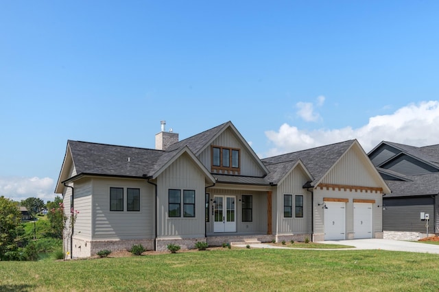 view of front of home with a garage and a front yard