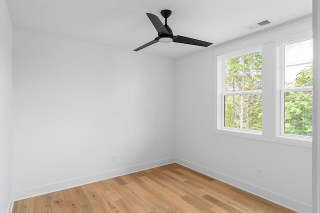 unfurnished room with ceiling fan and light wood-type flooring