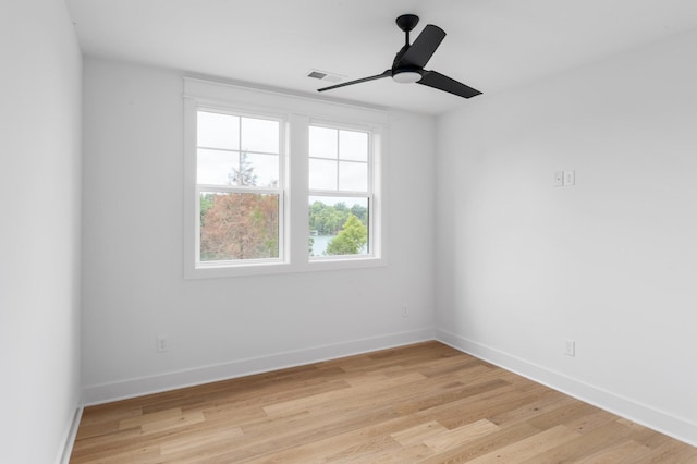 spare room with ceiling fan and light wood-type flooring