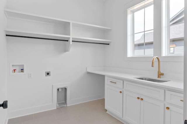 laundry room with sink, cabinets, light tile patterned floors, washer hookup, and hookup for an electric dryer