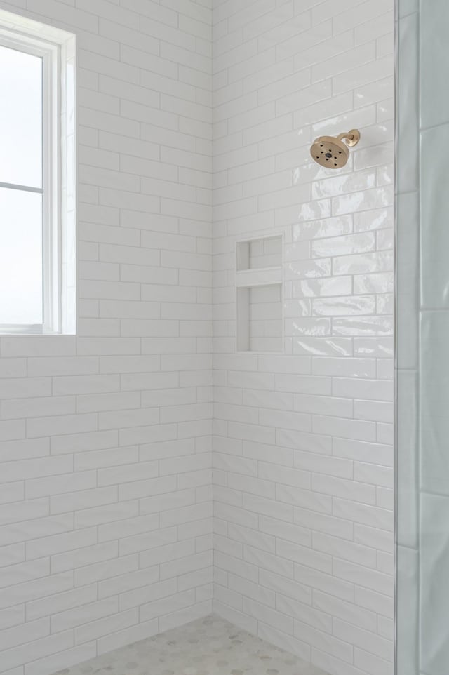 bathroom with a tile shower