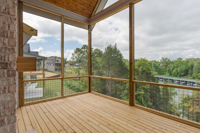 unfurnished sunroom with lofted ceiling