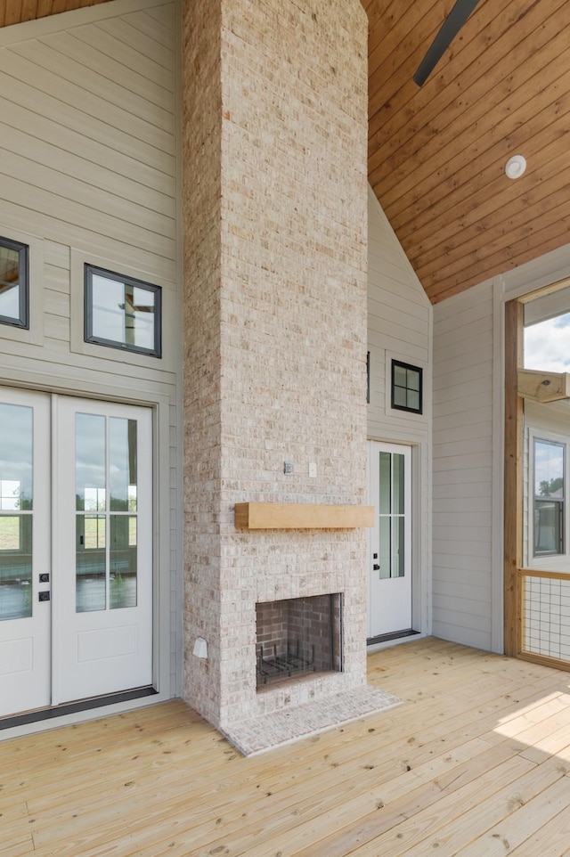 unfurnished living room with light hardwood / wood-style flooring, a wealth of natural light, and a large fireplace