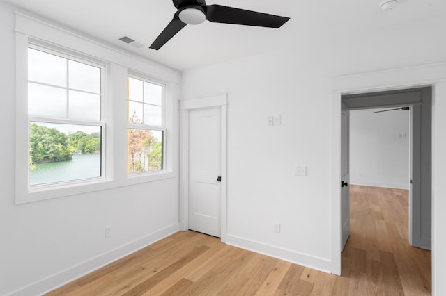 spare room featuring ceiling fan and light hardwood / wood-style flooring