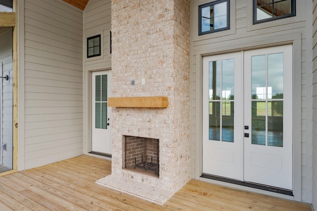 property entrance with an outdoor brick fireplace and french doors