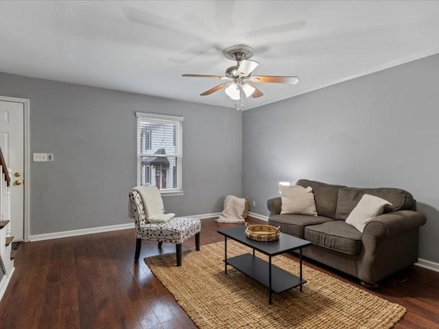 living room featuring ceiling fan and dark hardwood / wood-style flooring