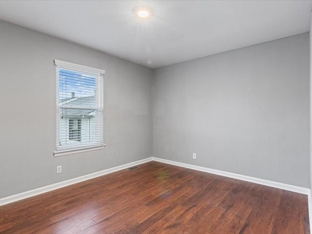 unfurnished room with dark hardwood / wood-style floors