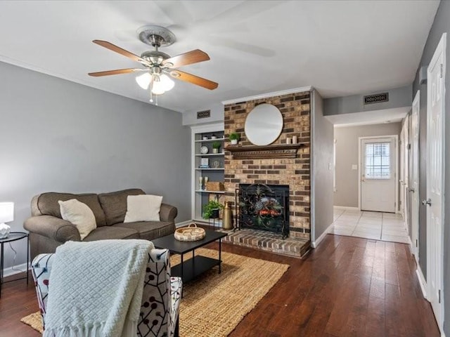 living room with hardwood / wood-style flooring, a fireplace, and ceiling fan