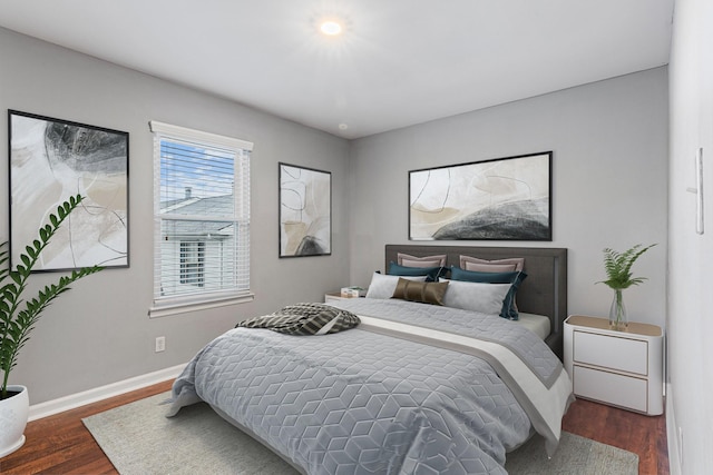 bedroom with dark hardwood / wood-style flooring