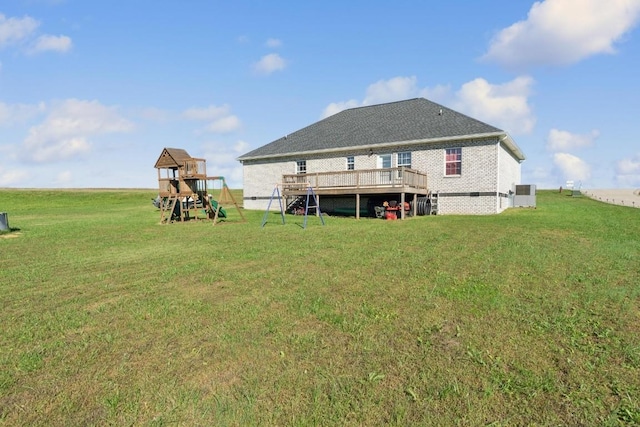 back of property featuring a yard and a playground