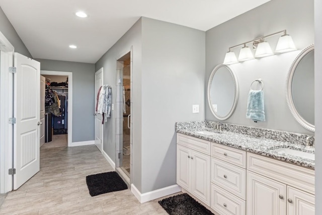 bathroom featuring vanity and an enclosed shower