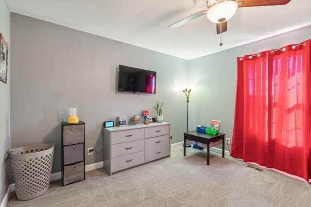 sitting room featuring ceiling fan and light carpet