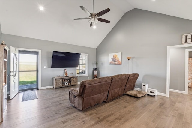 living room featuring wood-type flooring, high vaulted ceiling, and ceiling fan