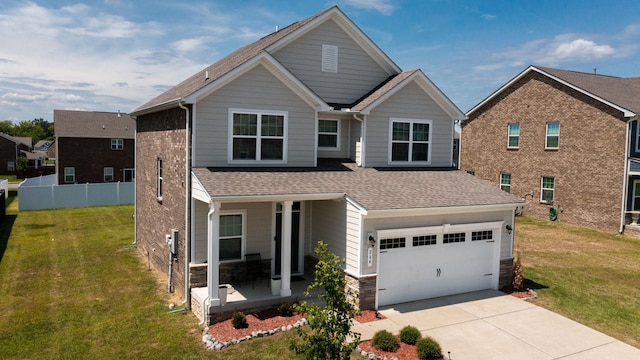 view of front of property with a garage, covered porch, and a front yard