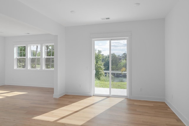 spare room featuring light hardwood / wood-style flooring