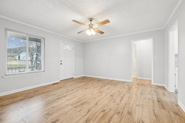 empty room with ceiling fan, ornamental molding, a textured ceiling, and light wood-type flooring