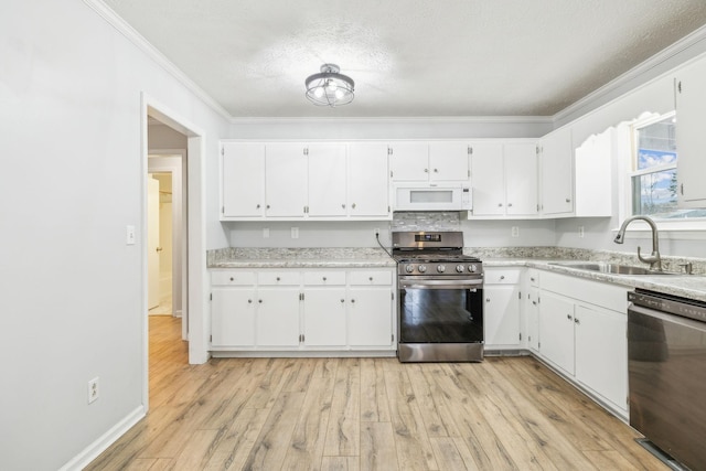 kitchen with sink, black dishwasher, gas stove, and white cabinets