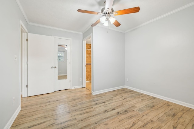 spare room featuring ornamental molding, ceiling fan, and light wood-type flooring