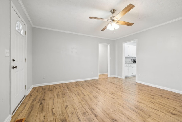 interior space featuring ornamental molding, light hardwood / wood-style floors, and ceiling fan