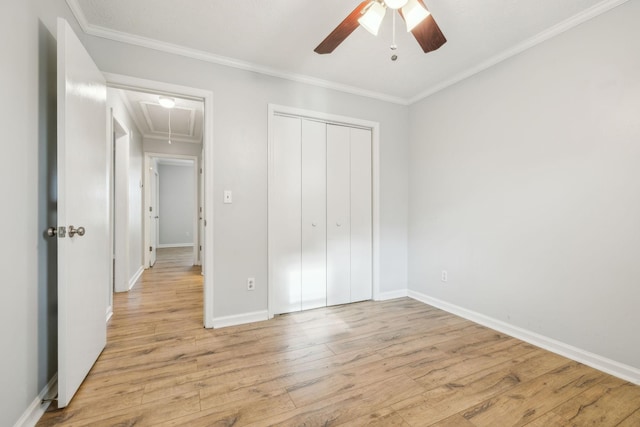 unfurnished bedroom featuring ornamental molding, a closet, ceiling fan, and light wood-type flooring