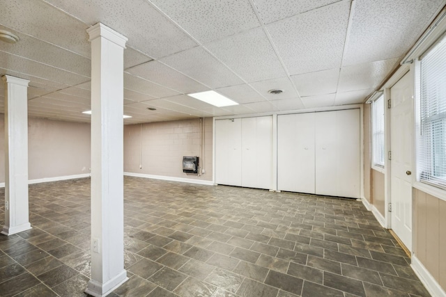 basement with heating unit and a drop ceiling