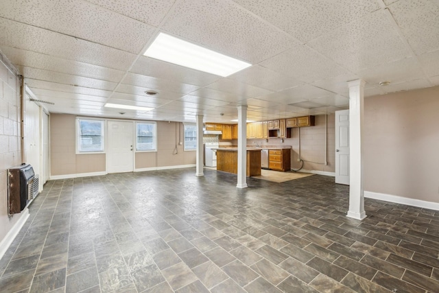 basement featuring heating unit and a drop ceiling