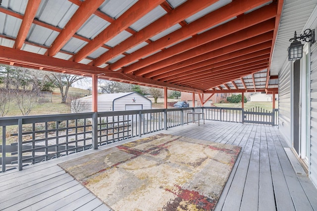 deck featuring a garage and an outdoor structure