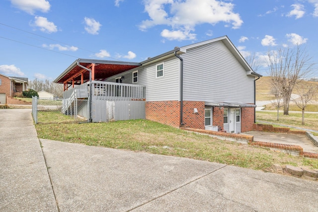 view of side of home featuring a yard