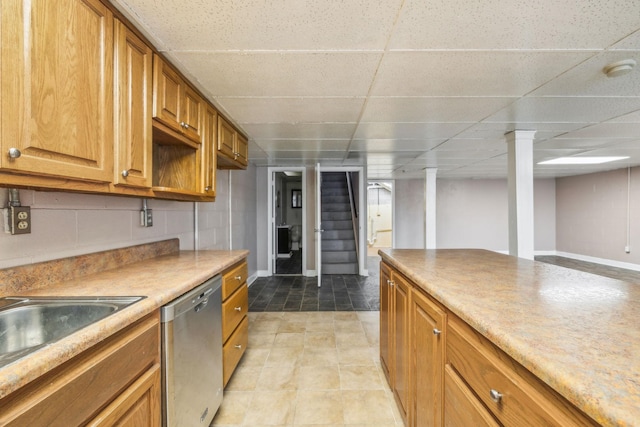 kitchen featuring dishwasher, sink, and a paneled ceiling