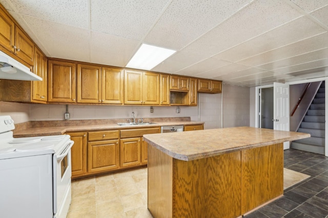 kitchen with sink, white electric stove, a paneled ceiling, a kitchen island, and stainless steel dishwasher