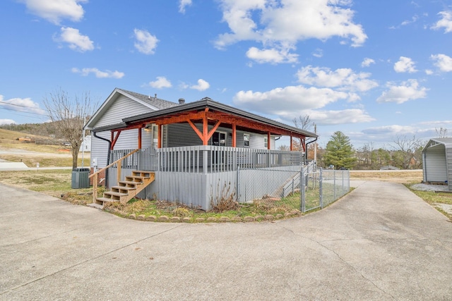 view of front of home featuring cooling unit and covered porch