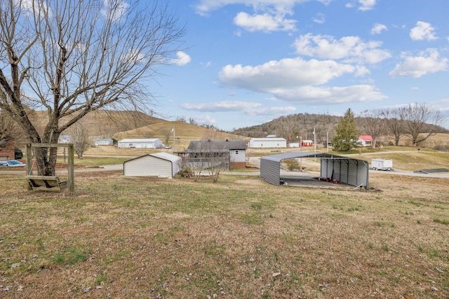 view of yard with a carport and a mountain view