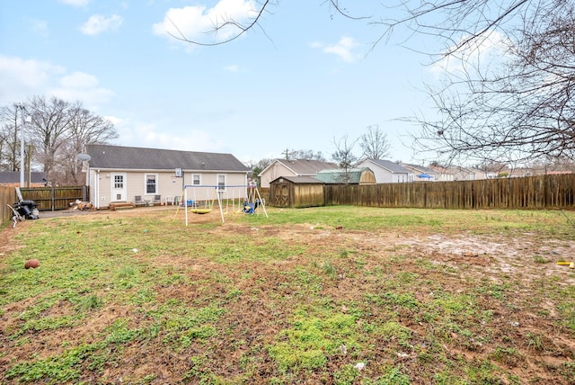 view of yard featuring a playground and a storage unit