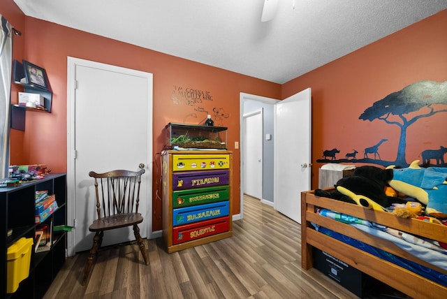 bedroom with wood-type flooring and ceiling fan