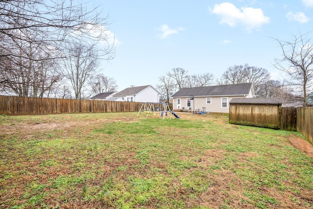 view of yard featuring a playground and a shed