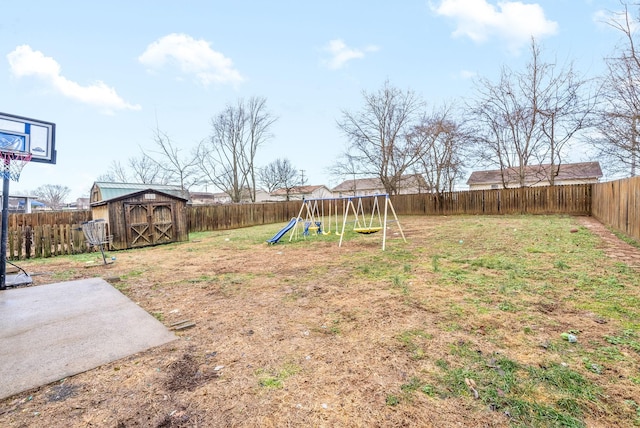 view of yard with a playground and a storage unit