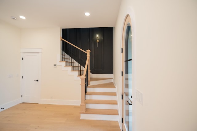 stairway with hardwood / wood-style flooring