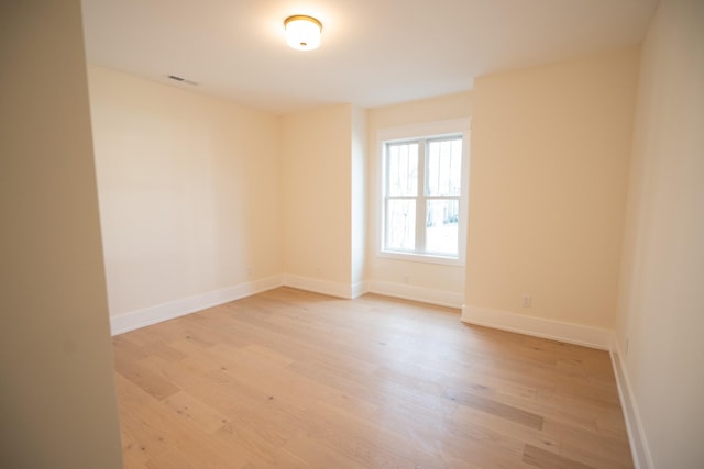 unfurnished room with light wood-type flooring