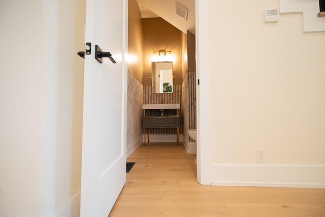 corridor with light hardwood / wood-style flooring